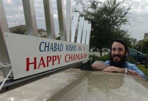 Rabbi Mendy Bukiet of Chabad of Bradenton displays a menorah on the roof of his 2003 Sonata, which will light up during Hanukkah.
